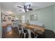 Elegant dining space with a rustic table, modern chairs, and seamless transition to kitchen at 6704 70Th N Ave, Pinellas Park, FL 33781