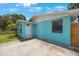 Close-up of a charming blue single-story house with a 'Welcome' sign and concrete driveway at 6704 70Th N Ave, Pinellas Park, FL 33781
