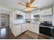Updated kitchen has white cabinets, stainless appliances, granite counters and dark laminate floor at 6704 70Th N Ave, Pinellas Park, FL 33781