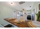 Bright kitchen features white cabinets, stainless steel appliances, and breakfast bar with chairs at 6704 70Th N Ave, Pinellas Park, FL 33781