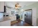 Well-lit kitchen showcases stainless steel appliances, granite counters, white cabinets, and eat-in space at 6704 70Th N Ave, Pinellas Park, FL 33781