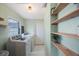 Laundry room equipped with shelving and white tile floor at 6704 70Th N Ave, Pinellas Park, FL 33781