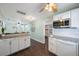 Open concept living space with kitchen bar, stainless appliances and laminate floors at 6704 70Th N Ave, Pinellas Park, FL 33781