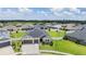 Aerial view of a well-maintained single-Gathering home with lush green grass and a white fenced-in backyard at 6879 Talamore Dr, Wesley Chapel, FL 33545