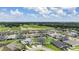 Expansive aerial view showcasing a well-planned community with neatly arranged homes, green spaces, and tranquil surroundings at 6879 Talamore Dr, Wesley Chapel, FL 33545