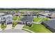 Aerial view of a well-maintained single-Gathering home with lush green grass and a white fenced-in backyard at 6879 Talamore Dr, Wesley Chapel, FL 33545