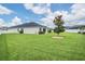 A spacious backyard featuring lush green grass and a well-maintained fence, perfect for outdoor activities at 6879 Talamore Dr, Wesley Chapel, FL 33545