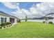 Expansive backyard with healthy lawn, neat landscaping, and white privacy fence at 6879 Talamore Dr, Wesley Chapel, FL 33545