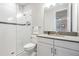 Modern bathroom featuring a glass-enclosed shower with white subway tile and a sleek vanity with white cabinets at 6879 Talamore Dr, Wesley Chapel, FL 33545