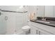 Modern bathroom featuring a glass-enclosed shower with white subway tile and a sleek vanity with dark cabinets at 6879 Talamore Dr, Wesley Chapel, FL 33545