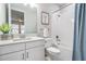 Bright bathroom featuring a shower-tub combo, single sink vanity, and classic design elements at 6879 Talamore Dr, Wesley Chapel, FL 33545