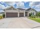 Charming single-Gathering home with a three-car garage, well-manicured lawn, and beautiful landscaping at 6879 Talamore Dr, Wesley Chapel, FL 33545