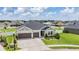 Attractive property featuring a two-car garage and manicured landscaping at 6879 Talamore Dr, Wesley Chapel, FL 33545