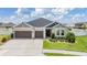 Charming home featuring a well-manicured lawn, complemented by a two-car garage at 6879 Talamore Dr, Wesley Chapel, FL 33545