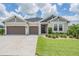 Charming single-Gathering home featuring a well-manicured lawn, neat landscaping, and a three-car garage at 6879 Talamore Dr, Wesley Chapel, FL 33545