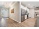 Open-concept home featuring a hallway that leads to a bright, modern kitchen with stainless steel appliances at 6879 Talamore Dr, Wesley Chapel, FL 33545
