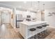 Modern kitchen featuring a large island with seating, stainless steel appliances, and an open floor plan at 6879 Talamore Dr, Wesley Chapel, FL 33545