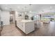 Open-concept kitchen featuring a large island, stainless steel appliances, and a view of the living room at 6879 Talamore Dr, Wesley Chapel, FL 33545