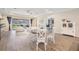 Open-concept living room features luxury vinyl flooring, recessed lighting and backyard views at 6879 Talamore Dr, Wesley Chapel, FL 33545
