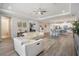 Open-concept living space with modern furniture, wood floors, and seamless flow to the dining area at 6879 Talamore Dr, Wesley Chapel, FL 33545