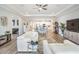 Bright and spacious living room flowing into the kitchen, featuring modern furnishings and decor at 6879 Talamore Dr, Wesley Chapel, FL 33545