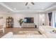 Bright living room with tray ceilings, wood floors, entertainment center, and an open concept layout at 6879 Talamore Dr, Wesley Chapel, FL 33545
