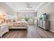 A serene bedroom with a tray ceiling, large window, and neutral color palette, offering a relaxing space at 6879 Talamore Dr, Wesley Chapel, FL 33545