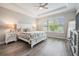 A serene bedroom with a tray ceiling, large window, and neutral color palette, offering a relaxing space at 6879 Talamore Dr, Wesley Chapel, FL 33545