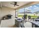 Covered patio featuring outdoor seating, a grill, and a fire pit, perfect for entertaining at 6879 Talamore Dr, Wesley Chapel, FL 33545