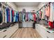 Spacious walk-in closet featuring custom shelving, drawers, and ample storage space for an organized wardrobe at 6879 Talamore Dr, Wesley Chapel, FL 33545