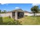 View of the backyard with a screened in patio and green lawn at 7120 Forest Mere Dr, Riverview, FL 33578