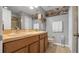 Neutral bathroom featuring a double sink vanity, toilet, and a walk-in shower at 7120 Forest Mere Dr, Riverview, FL 33578