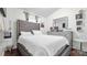 Bedroom with gray upholstered bed, dresser, and modern decor at 7120 Forest Mere Dr, Riverview, FL 33578