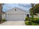 Inviting single-Gathering home with a manicured lawn, a two-car garage and a welcoming entryway at 7120 Forest Mere Dr, Riverview, FL 33578