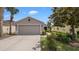 Charming single-story home featuring a well-manicured lawn and a two-car garage at 7120 Forest Mere Dr, Riverview, FL 33578