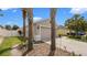A cozy home with mature palm trees, a two-car garage, and a well-kept lawn at 7120 Forest Mere Dr, Riverview, FL 33578