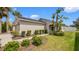 Charming single-story home featuring lush landscaping and a welcoming front entrance with an arched doorway at 7120 Forest Mere Dr, Riverview, FL 33578