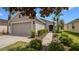 Attractive home with well-maintained landscaping, a two-car garage, and a cozy front entrance at 7120 Forest Mere Dr, Riverview, FL 33578