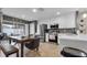 Bright kitchen boasts stainless steel appliances, white cabinetry, tile backsplash, and a dining area with modern furniture at 7120 Forest Mere Dr, Riverview, FL 33578