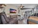 Open-concept living room with wood flooring, a ceiling fan, and modern decor at 7120 Forest Mere Dr, Riverview, FL 33578