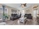 Cozy living room featuring hardwood floors, leather sofas and a ceiling fan for a comfortable atmosphere at 7120 Forest Mere Dr, Riverview, FL 33578