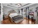 Luxurious main bedroom with elegant furniture, hardwood floors, and natural light at 7120 Forest Mere Dr, Riverview, FL 33578