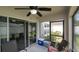 Screened in patio with fan and outdoor seating with access to the backyard at 7120 Forest Mere Dr, Riverview, FL 33578