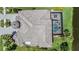 An aerial view of a private home with a pool and a uniquely designed roof at 7162 Graybrook Dr, Wesley Chapel, FL 33545
