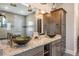 Stylish bathroom featuring vessel sinks, granite countertops, a large mirror, and pendant lighting at 7162 Graybrook Dr, Wesley Chapel, FL 33545