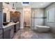 Luxurious bathroom with a soaking tub, glass shower, pendant lighting, and modern vessel sinks at 7162 Graybrook Dr, Wesley Chapel, FL 33545