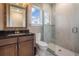 Modern bathroom with a glass shower, granite countertop, and wood cabinets at 7162 Graybrook Dr, Wesley Chapel, FL 33545