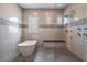 Modern bathroom featuring a freestanding tub, frameless shower, and mosaic tile accents at 7162 Graybrook Dr, Wesley Chapel, FL 33545