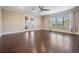 Bright bedroom with hardwood floors, large window, and sliding glass doors to a balcony at 7162 Graybrook Dr, Wesley Chapel, FL 33545