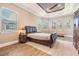 Serene main bedroom featuring trey ceiling, neutral paint colors, and wood floors at 7162 Graybrook Dr, Wesley Chapel, FL 33545